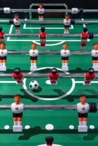 group of people playing soccer game table combo foosball