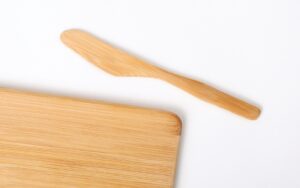 a wooden spoon on a white background bamboo cutting board