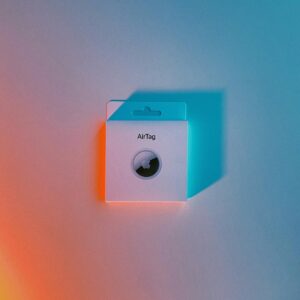 pink and white speaker on pink surface apple air tag