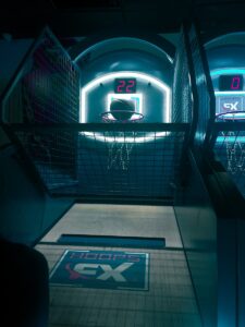 a basketball court with neon lights and a basketball hoop arcade basketball