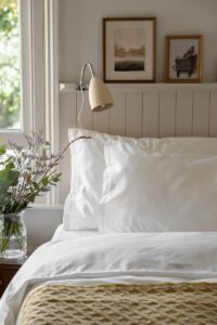 a bed with a white comforter and pillows bedding sheets